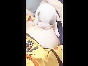 Woman Breastfeeds Her Puppy